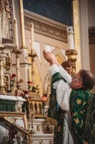 Why does the priest face the altar in the Latin Mass