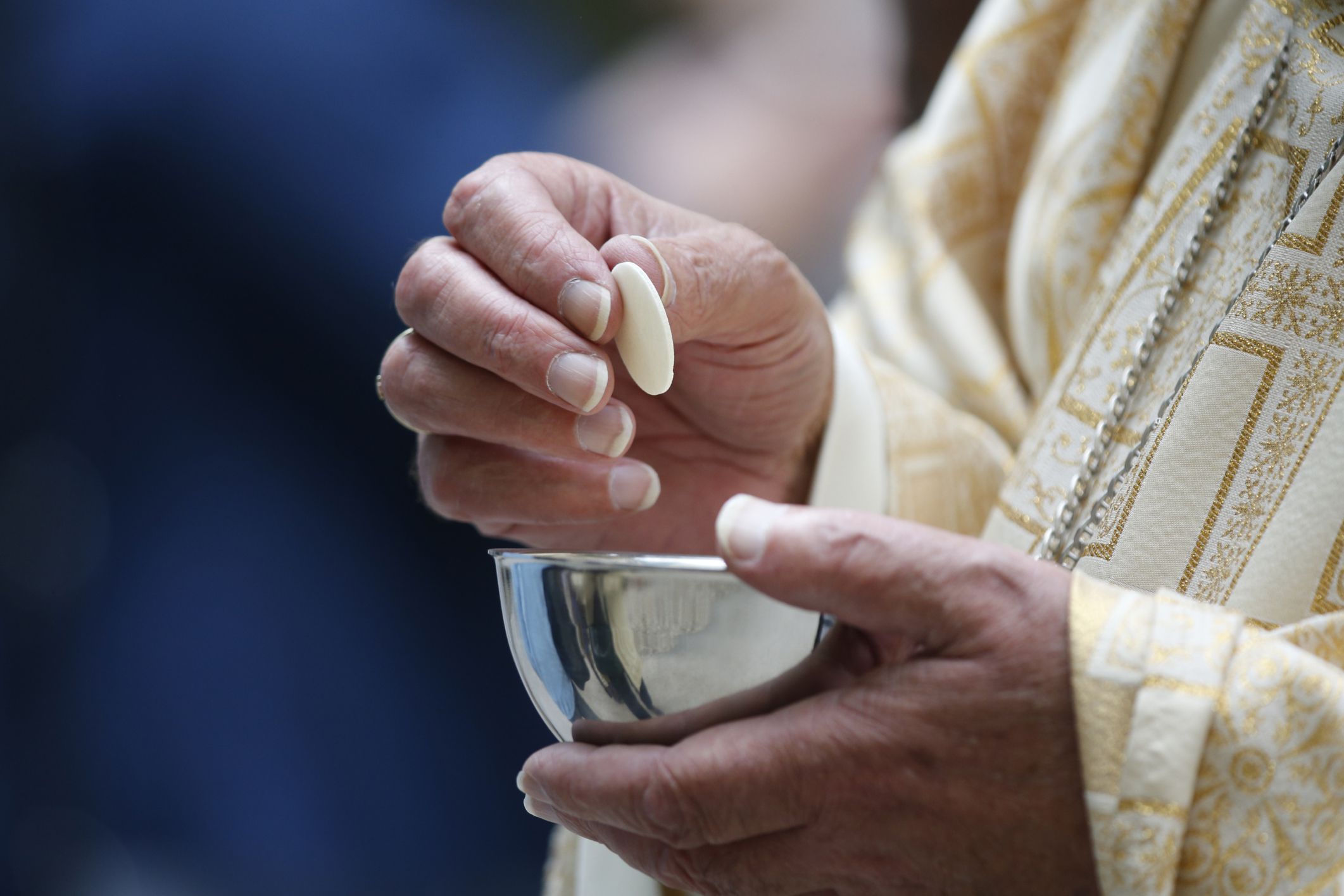 priest distributing holy communion